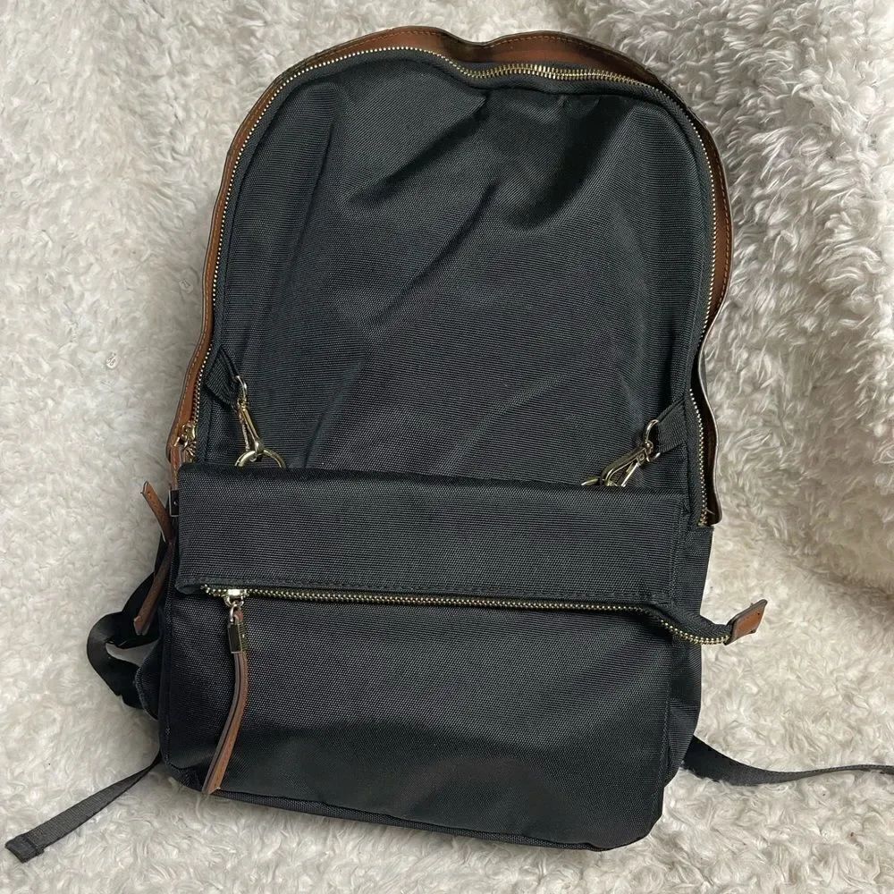 Tommy Bahama Black  Laptop Case Backpack With Brown trims and straps .